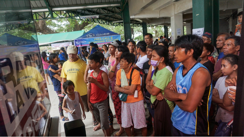 Evacuees watch television intently, as they wait on news about the homes they’ve left behind.