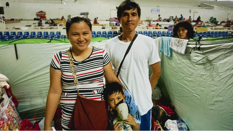 Maricel and Allan, together with their son, inside the modular tent assigned to them and three more family members.